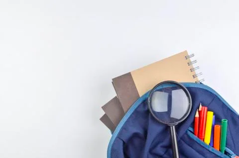 View of flat lay with school backpack and stationery with space for text on w Stock Photos