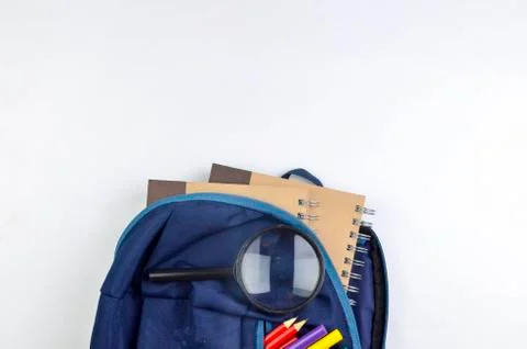 View of flat lay with school backpack and stationery with space for text on w Stock Photos