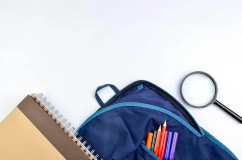 View of flat lay with school backpack and stationery with space for text on w Stock Photos