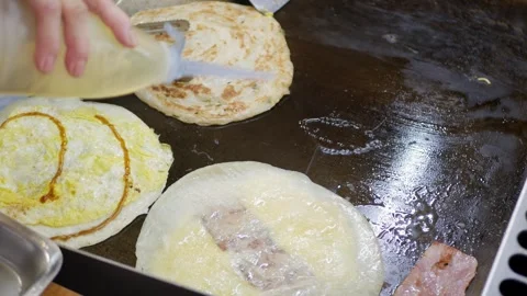 View to the flat pan while cooking fried pancake roti in taiwanese style wi.. Stock Footage 256859389