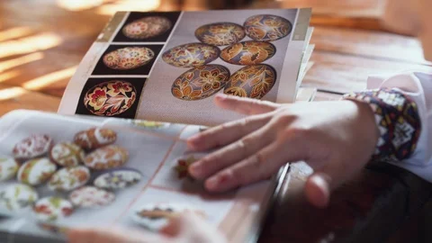 View of flipping book with painted patterns of easter eggs Stock Footage 115052686