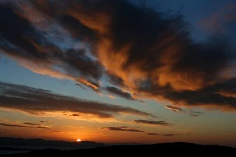 View of floating clouds at sunset Stock Photos