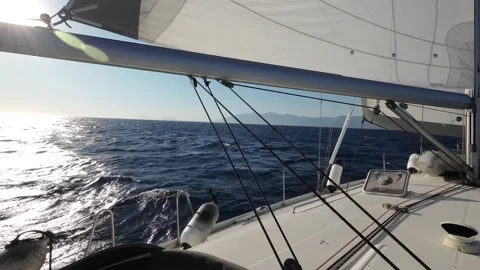 View from a floating sailing yacht with spread sails splitting the sea waves Stock Footage 204058967