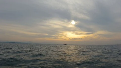 View of a floating ship in the sea while travelling in a boat, India Stockbeeldmateriaal 122572873