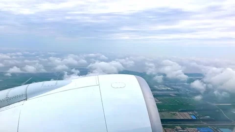 The view of floating white clouds and a town, taken from a plane window Stock Footage 150198058