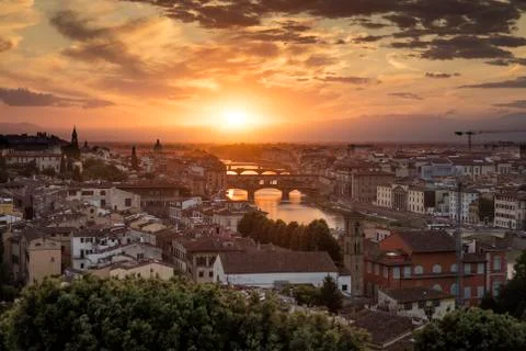 View of Florence during sunset showing the River Arno and the Ponte Vecchio - Stock Photos