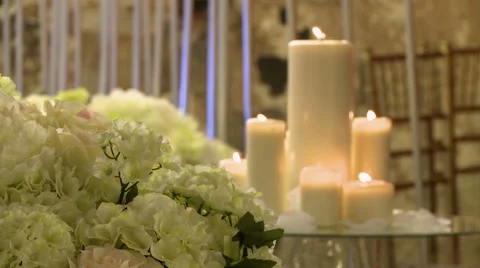 View of flowers and lighted candles on glass table Stock Footage 44795743