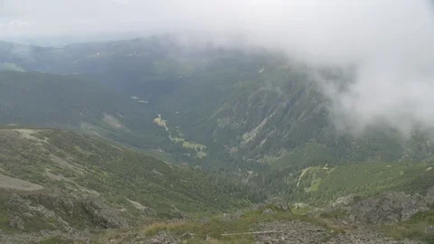 View on flowing clouds. Hills in background Stock-Footage 79767141