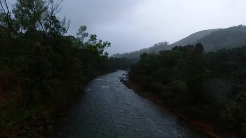 View of a flowing river on a rainy day, in a forest in India. Stock Footage 119313766