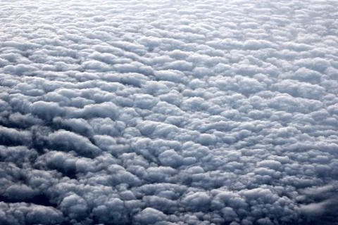 View of fluffy and  white  clouds from the plane window Stock Photos