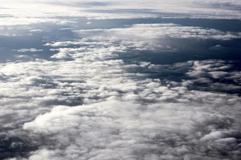 View of fluffy and white clouds from the plane window Stock Photos