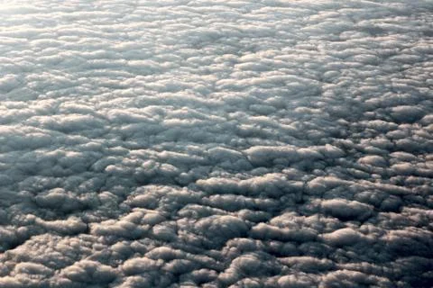 View of fluffy clouds from the plane window Stock Photos