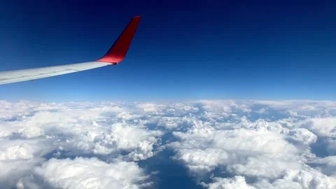 View from flying airplane window to airplane wing above the sky. Stock Footage 310698109