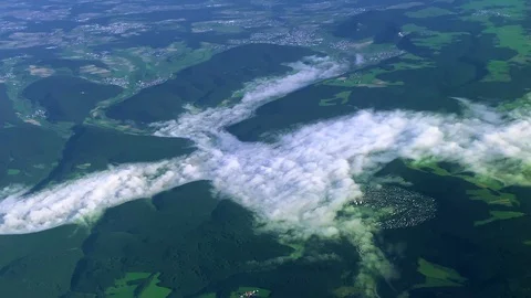 View from a flying plane of clouds and mountains over the Swiss Alps Stock Footage 114547308
