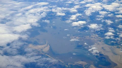 The view from a flying plane to the ground through white clouds. copy space Stock Footage 140715361