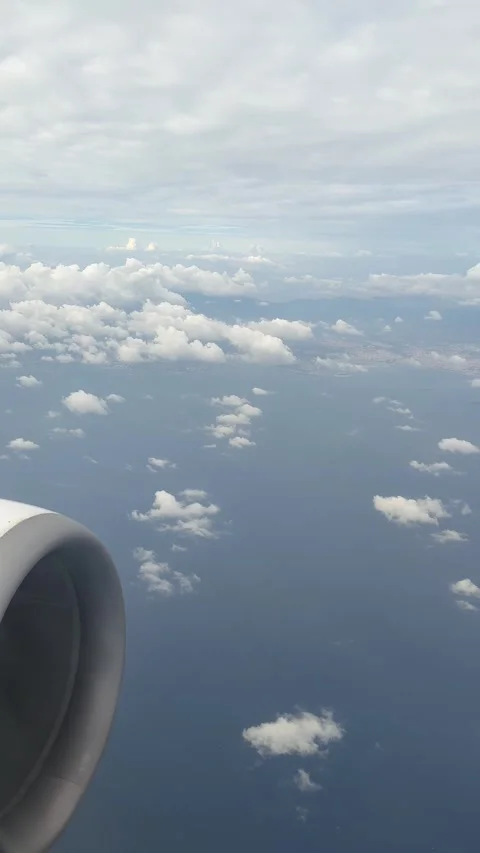 View from the flying plane window on many tiny clouds and blue sky with air.. Stock Footage 324577045
