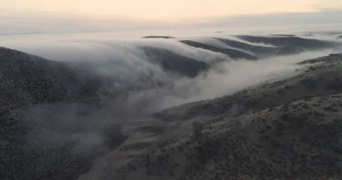 View of fog going into the valley below Stock Footage 159248536
