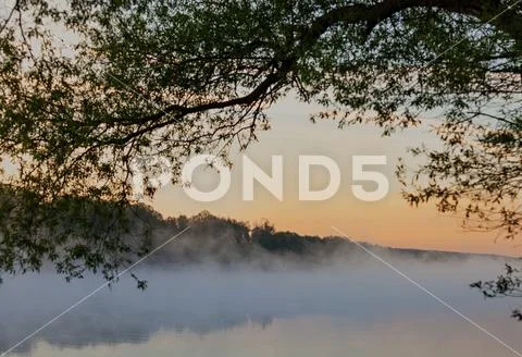 A view of the fog over the river in the early morning. Selective focus Stock Photos