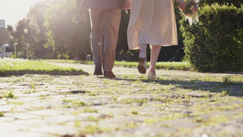 View of foot or legs of man in suit and woman in elegant dress, who go into Stock Footage 200850841