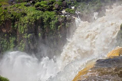 View of the force of the water at the edge of a waterfall at Iguazu Falls, .. Stock Photos