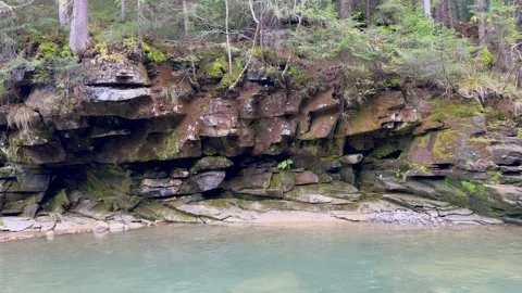 View of forest lake with rocks and trees. Stock Footage 254521706