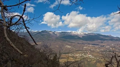 View from the forest through branches to mountains with green slopes covered Stock Footage 172434638