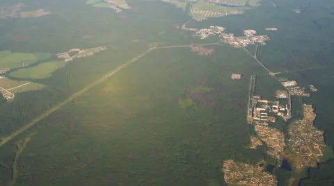 View of forests and settlements with flying airplane Stock Footage 52888986
