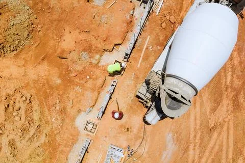 View of foundation preparation at construction site, with a concrete mixer truck Stockfoto's