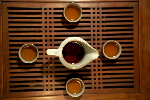 View Of Four Tea Cups And A Teapot From Directly Above Stock Photos
