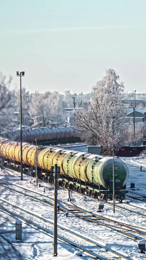 View of a freight train with yellow tanker cars in Latvia. Stock Footage 339901265