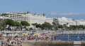 View French Riviera People Sunbathe Sunbathing Swimming Beach Umbrella Cannes HD Footage