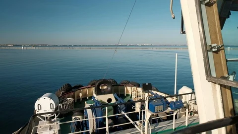 View of the front bow part of the towing vessel sailing into the sea on a bright Stock Footage 99586271