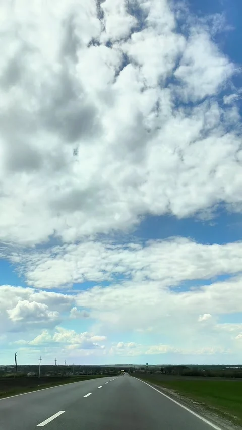 View from front car window on open highway, clear road stretching into distance, Stock Footage 338248405