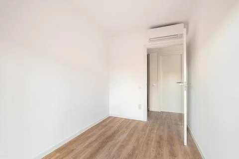 View of the front door to compact bright empty room without furniture with Stock Photos