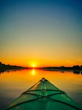 View of front of kayak, floating on the river at sunset 스톡 사진