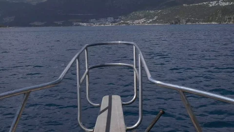 View from front of a sail boat as it gets close to a Mediterranean beach town 스톡 동영상 108371062