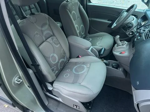 View of front seats in a small car with patterned upholstery and simple int.. Stock Photos