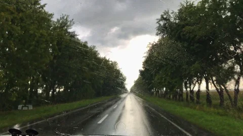 The view from the front window of the car with working windshield wipers duri Stock Footage 118520825