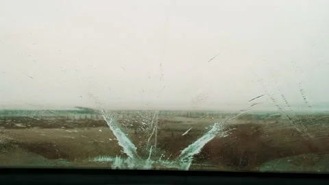 The view from the front window of the car with working windshield wipers during 動画素材 169243782