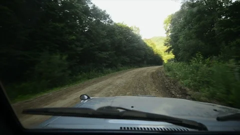 View from a front window of a cross over going across country through the forest Vidéo 89022404