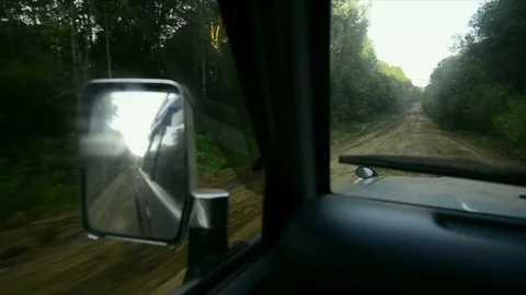 View from a front window of a cross over going across country through the forest Vidéo 89023007