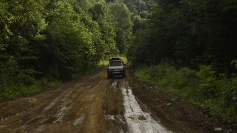 View from a front window of a cross over going across country through the forest 動画素材 89023053