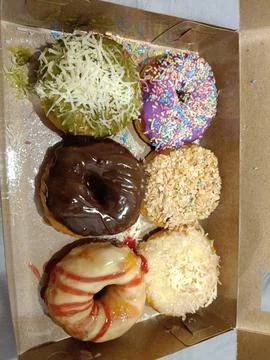 View of a full box of high-calorie snacks Stock Photos