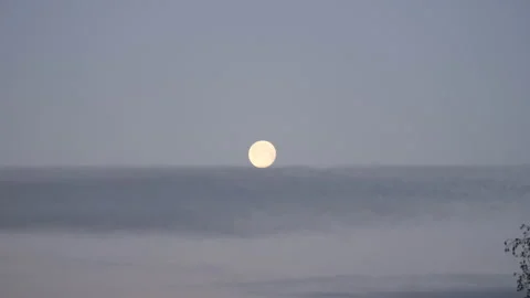 A view of the full moon and clouds early morning. Stock Footage 169465483