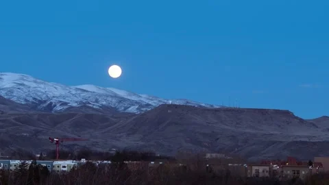 View of full moon over snow-capped mountains in Boise, United States. Video stock 344411841