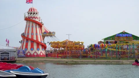 View of the fun park next to a lake in Skegness, Lincolnshire, UK Stock Footage 242325852