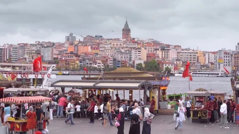 View of Galata Bridge and a square full of people and food stalls in Istanbul. Video stock 150864527