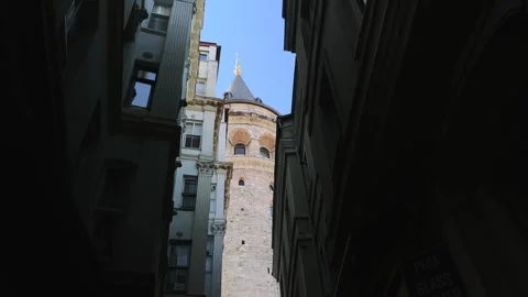 View of the Galata Tower framed between narrow shadowed buildings in the Stock Footage 321289175