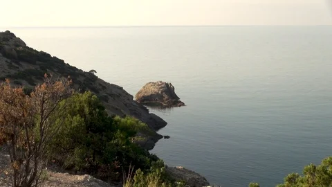 View from Galitsyn trail on boulders emerging from waters of calm sea. Video stock 108335129