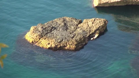 View from Galitsyn trail to rock in sea. Emerald clear water around rock. Stock Footage 108429404